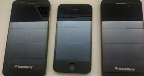 the upcoming blackberry z10 gets torn apart poses next to the iphone-logo